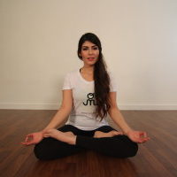 Young woman sitting doing pranayam meditation yoga | Santosh Yoga Institute in Salt Lake City, UT