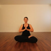 Young woman sitting doing pranayam meditation yoga | Santosh Yoga Institute in Salt Lake City, UT