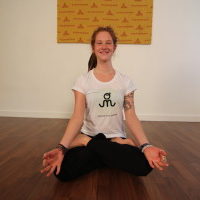 Young woman sitting doing pranayam meditation yoga | Santosh Yoga Institute in Salt Lake City, UT