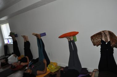 Group of young people practicing yoga | Santosh Yoga Institute in Salt Lake City, UT