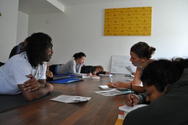 Group of young people lying on the floor writing in notebooks | Santosh Yoga Institute in Salt Lake City, UT