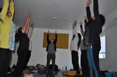 Group of young people practicing yoga | Santosh Yoga Institute in Salt Lake City, UT
