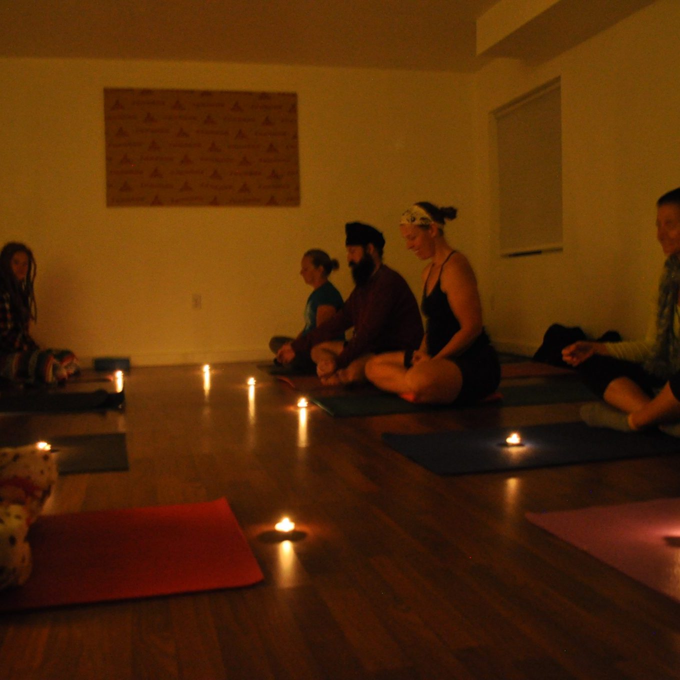 Group of People Doing Candle Meditation Yoga | Santosh Yoga Institute in Salt Lake City, UT