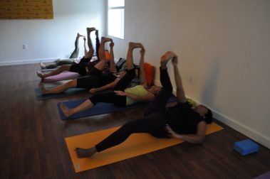 Group of young people practicing yoga | Santosh Yoga Institute in Salt Lake City, UT