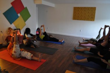 Group of young people practicing yoga | Santosh Yoga Institute in Salt Lake City, UT