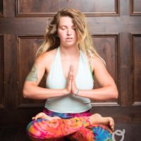 Young woman sitting doing meditation yoga | Santosh Yoga Institute in Salt Lake City, UT