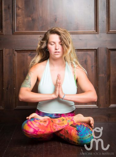 Young woman sitting doing meditation yoga | Santosh Yoga Institute in Salt Lake City, UT