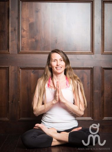 Young woman sitting doing meditation yoga | Santosh Yoga Institute in Salt Lake City, UT