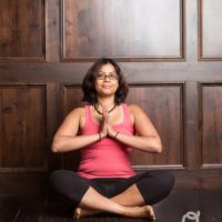 Young woman sitting doing meditation yoga | Santosh Yoga Institute in Salt Lake City, UT
