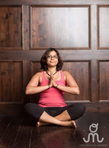 Young woman sitting doing meditation yoga | Santosh Yoga Institute in Salt Lake City, UT