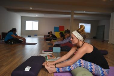 Group of young people practicing yoga | Santosh Yoga Institute in Salt Lake City, UT