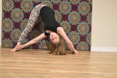 Flexible young woman practicing yoga | Santosh Yoga Institute in Salt Lake City, UT