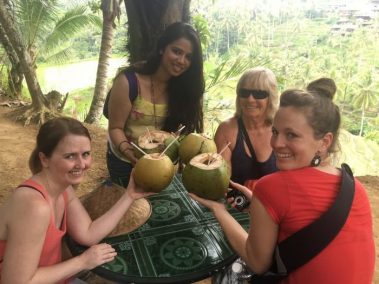 Young females drinking coconut water | Santosh Yoga Institute in Salt Lake City, UT