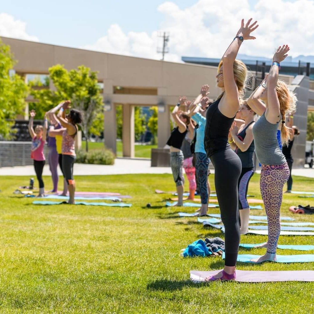Group of people practicing yoga outdoors in Salt Lake City, UT | Santosh Yoga Institute