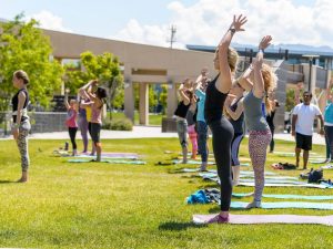 Group of people practicing yoga outdoors in Salt Lake City, UT | Santosh Yoga Institute