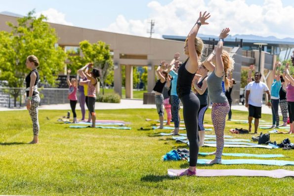 Group of people practicing yoga outdoors in Salt Lake City, UT | Santosh Yoga Institute