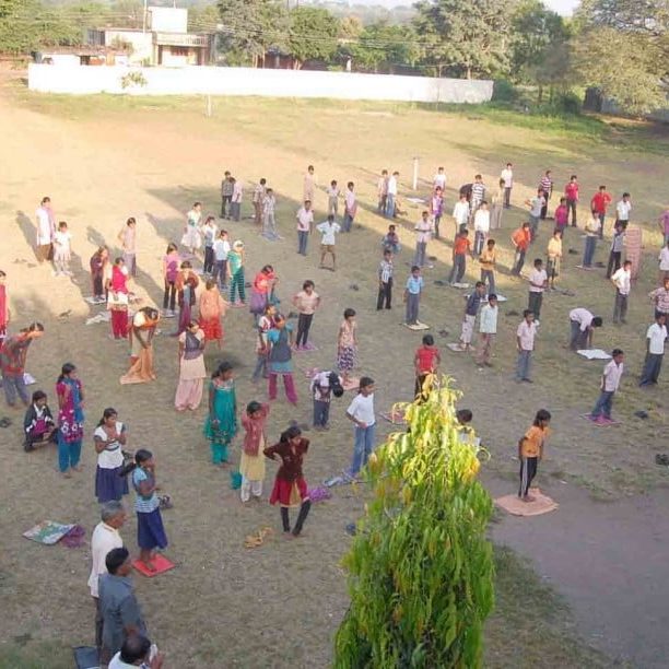 Group of people practicing yoga outdoors in Salt Lake City, UT | Santosh Yoga Institute