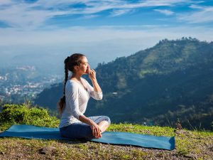 Young female doing pranayam yoga outdoor | Santosh Yoga Institute in Salt Lake City, UT
