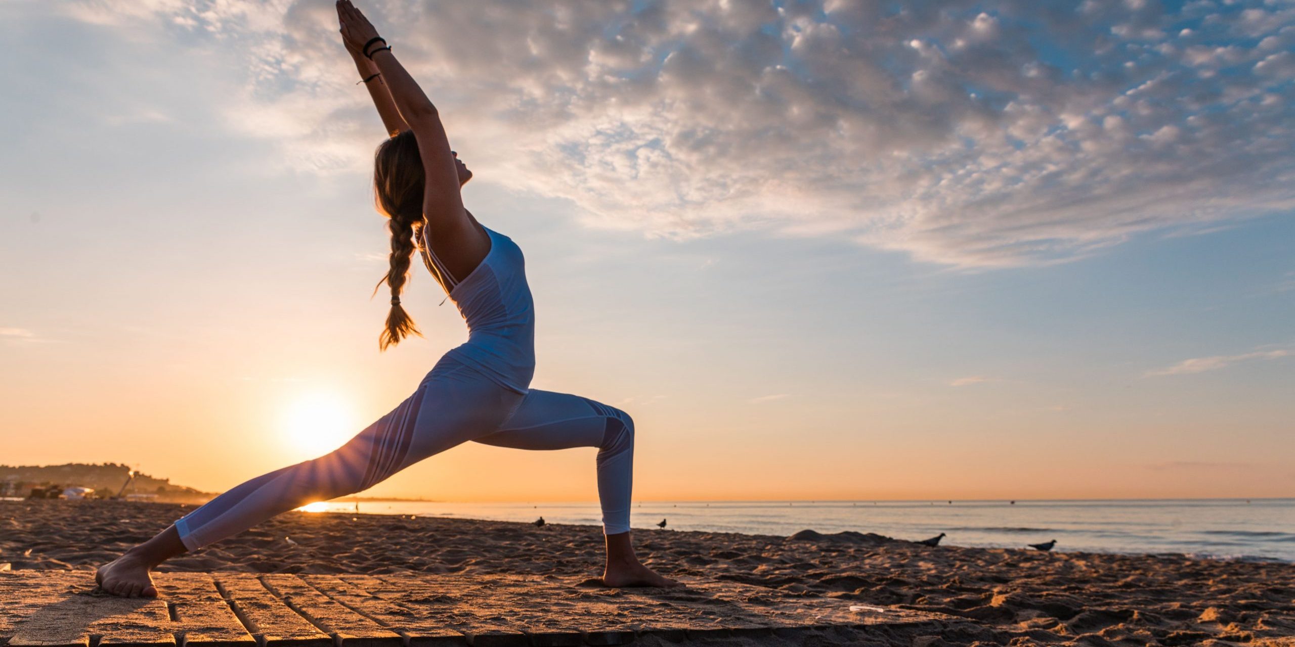 Flexible woman doing hard excersise outdoors | Santosh Yoga Institute in Salt Lake City, UT