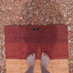 Woman Outdoors Using Cotton Rug Yoga Mat Red Rock in Salt Lake City, UT | Santosh Yoga Institute