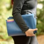 Woman holding Tapas Travel Mat in Salt Lake City, UT | Santosh Yoga Institute