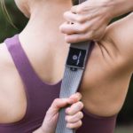 Young female doing yoga using D-Ring Yoga Strap in Salt Lake City, UT | Santosh Yoga Institute