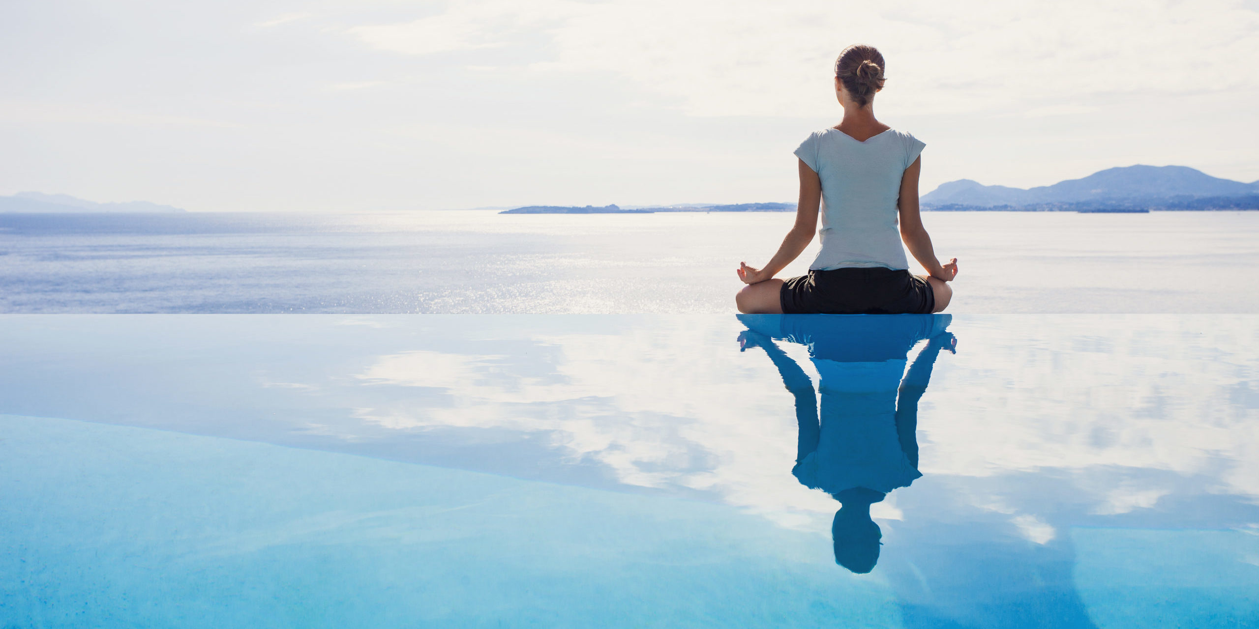 Woman sitting in a beautiful calm place doing meditation in Salt Lake City, UT | Santosh Yoga Institute