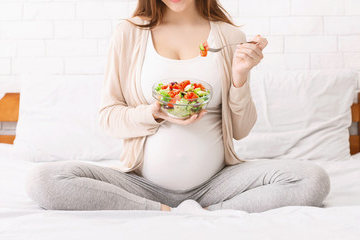 Pregnant woman eating healthy food in Salt Lake City, UT | Santosh Yoga Institute