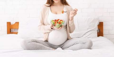 Pregnant woman eating healthy food in Salt Lake City, UT | Santosh Yoga Institute