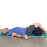 Man doing yoga with Round Yoga Bolster in Salt Lake City, UT | Santosh Yoga Institute