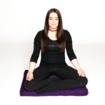 Woman doing yoga sitting on Zabuton Meditation Pillow in Salt Lake City, UT | Santosh Yoga Institute