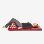 Young girl lying on Zafuko Thai Bed in Salt Lake City, UT | Santosh Yoga Institute
