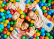 Cute kids lying on balls showing their hands in Salt Lake City, UT | Santosh Yoga Institute