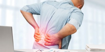 Man suffering from back pain in Salt Lake City, UT | Santosh Yoga Institute