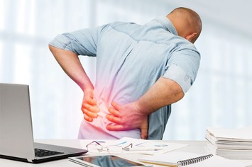 Man suffering from back pain in Salt Lake City, UT | Santosh Yoga Institute