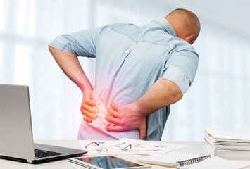 Man suffering from back pain in Salt Lake City, UT | Santosh Yoga Institute