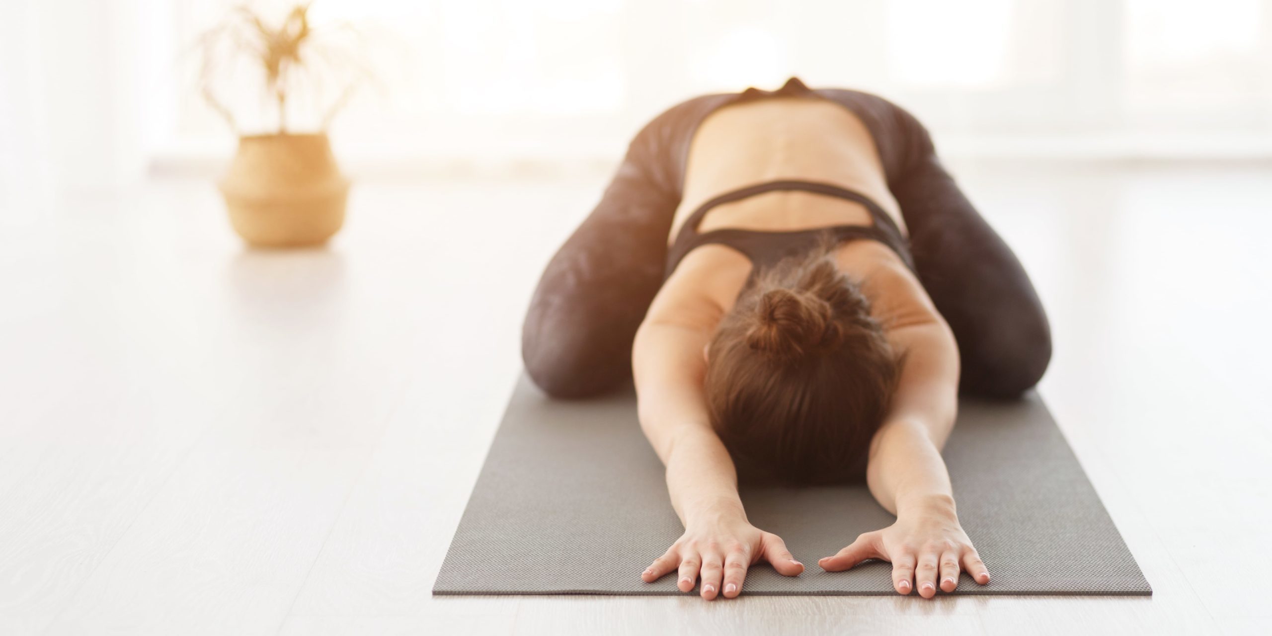 Young woman doing Balasana yoga pose in Salt Lake City, UT | Santosh Yoga Institute