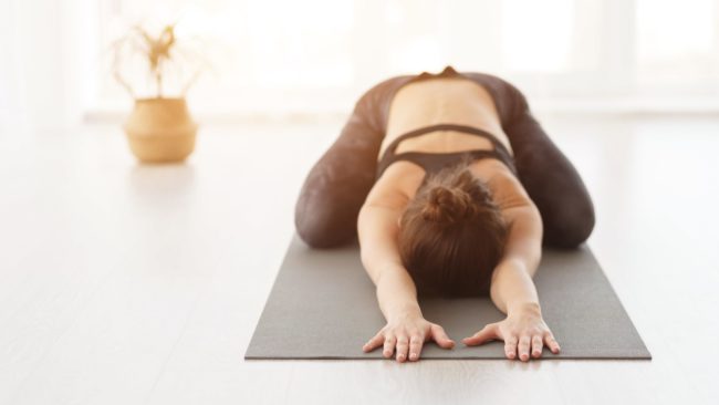 Young woman doing Balasana yoga pose in Salt Lake City, UT | Santosh Yoga Institute