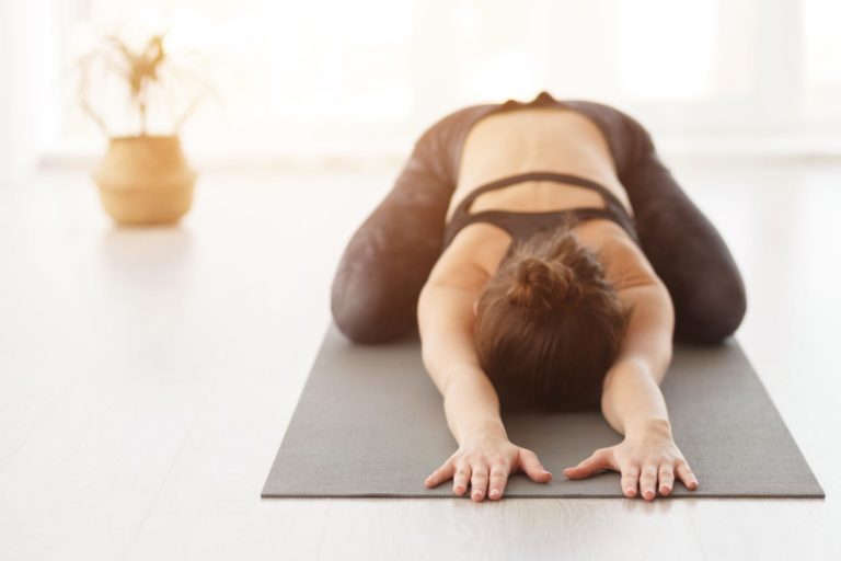 Young woman doing Balasana yoga pose in Salt Lake City, UT | Santosh Yoga Institute