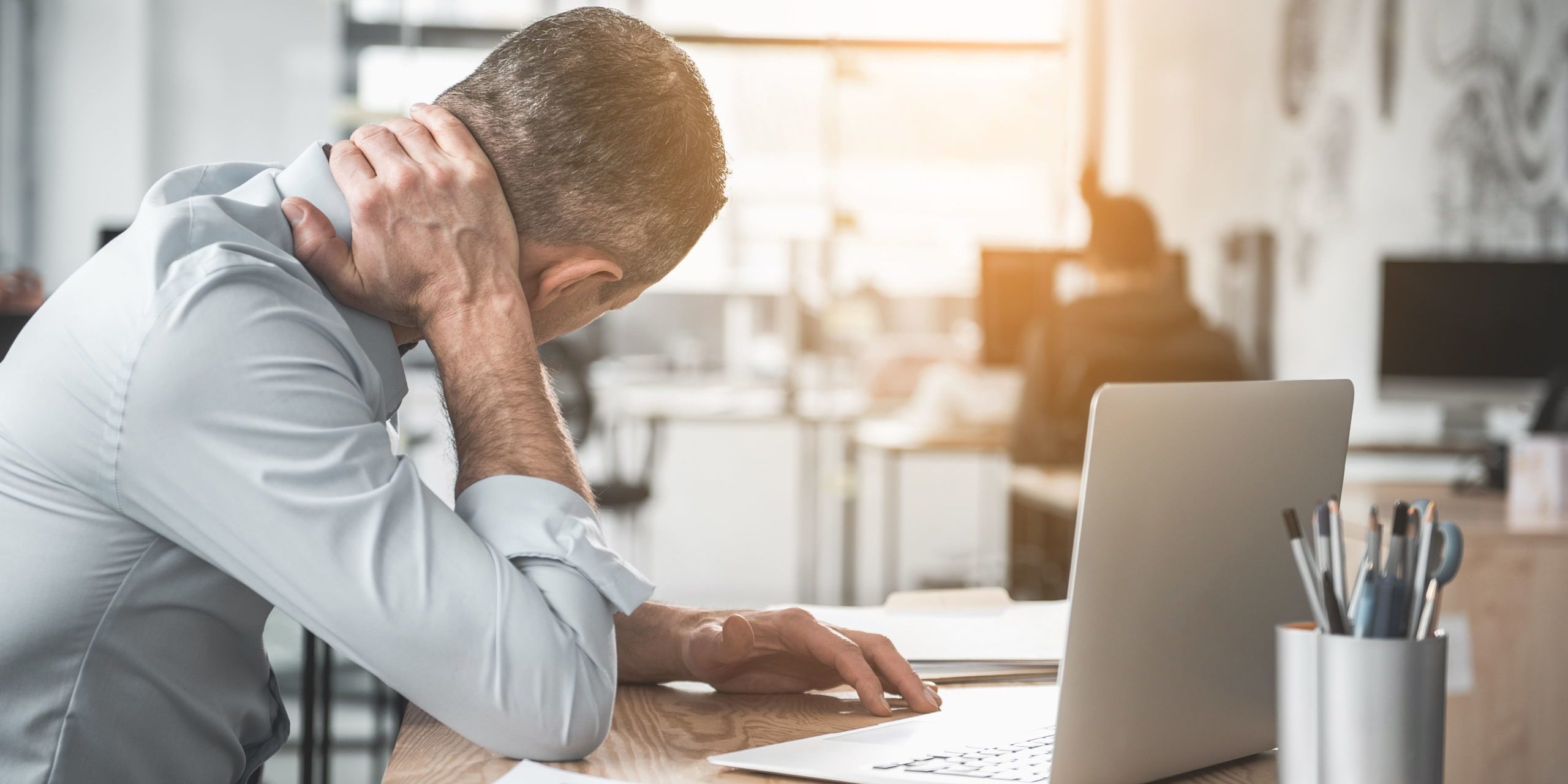 Stressed man in office Photo in Salt Lake City, UT | Santosh Yoga Institute