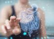 Woman pointing finger on Human Digestive System Picture in Salt Lake City, UT | Santosh Yoga Institute
