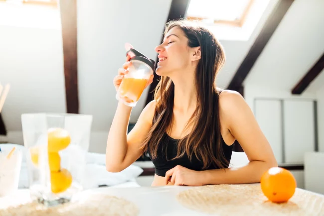 Young woman drinking healthy fruit juice in Salt Lake City, UT | Santosh Yoga Institute