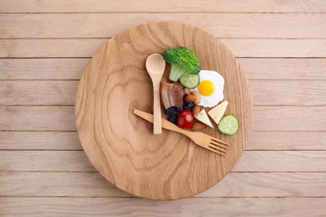 Healthy food clock. in wooden table in Salt Lake City, UT | Santosh Yoga Institute