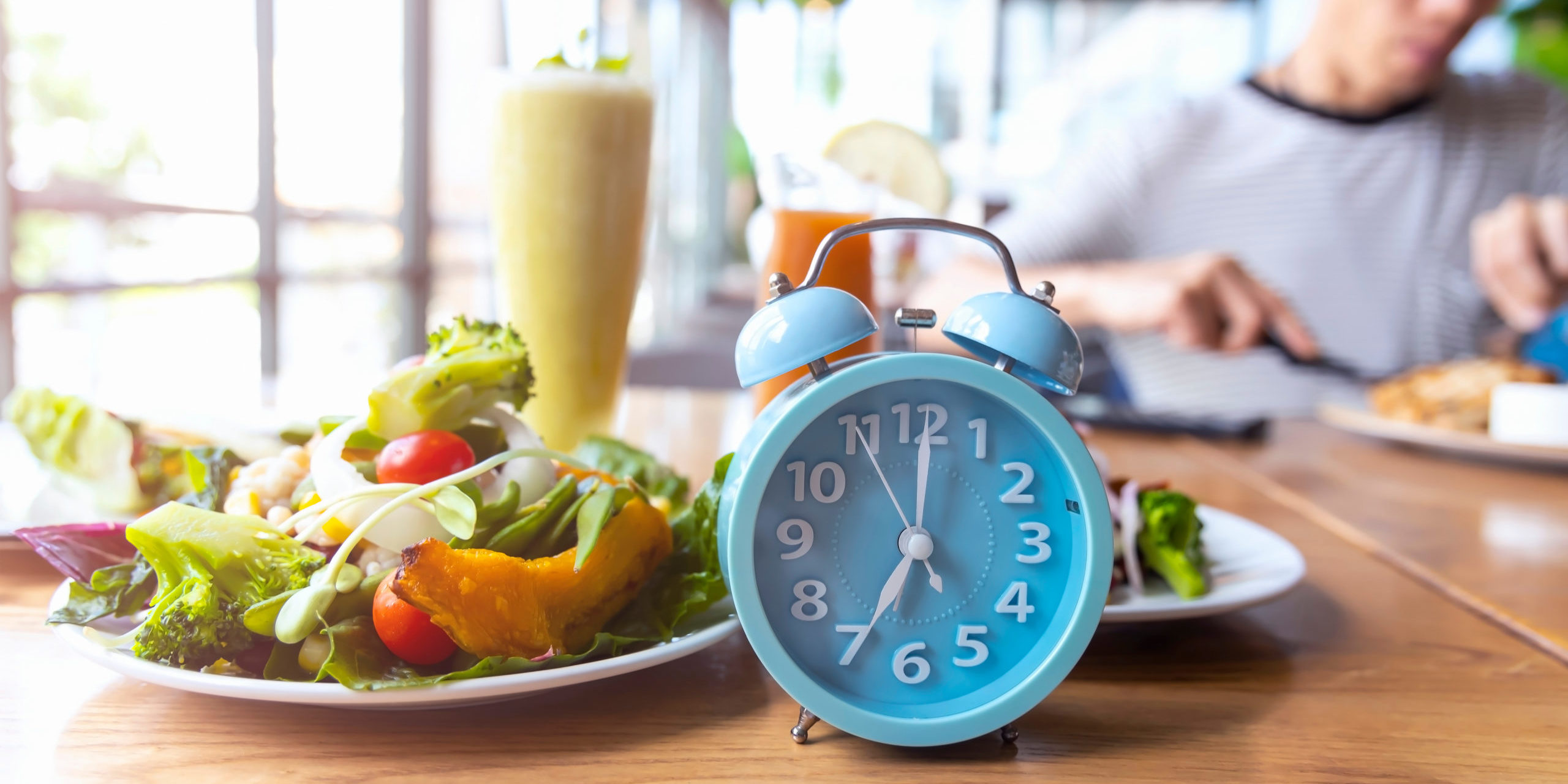 Food and alarm clock on the table in Salt Lake City, UT | Santosh Yoga Institute
