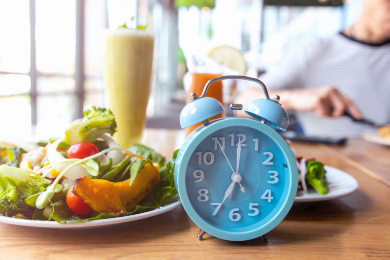 Food and alarm clock on the table in Salt Lake City, UT | Santosh Yoga Institute