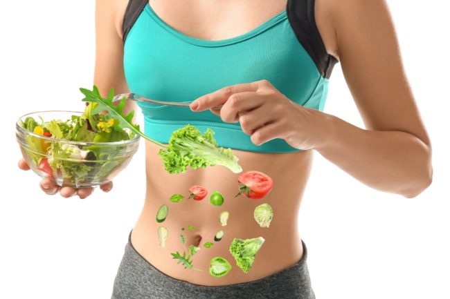 Fit woman holding healthy food bowl on hands in Salt Lake City, UT | Santosh Yoga Institute