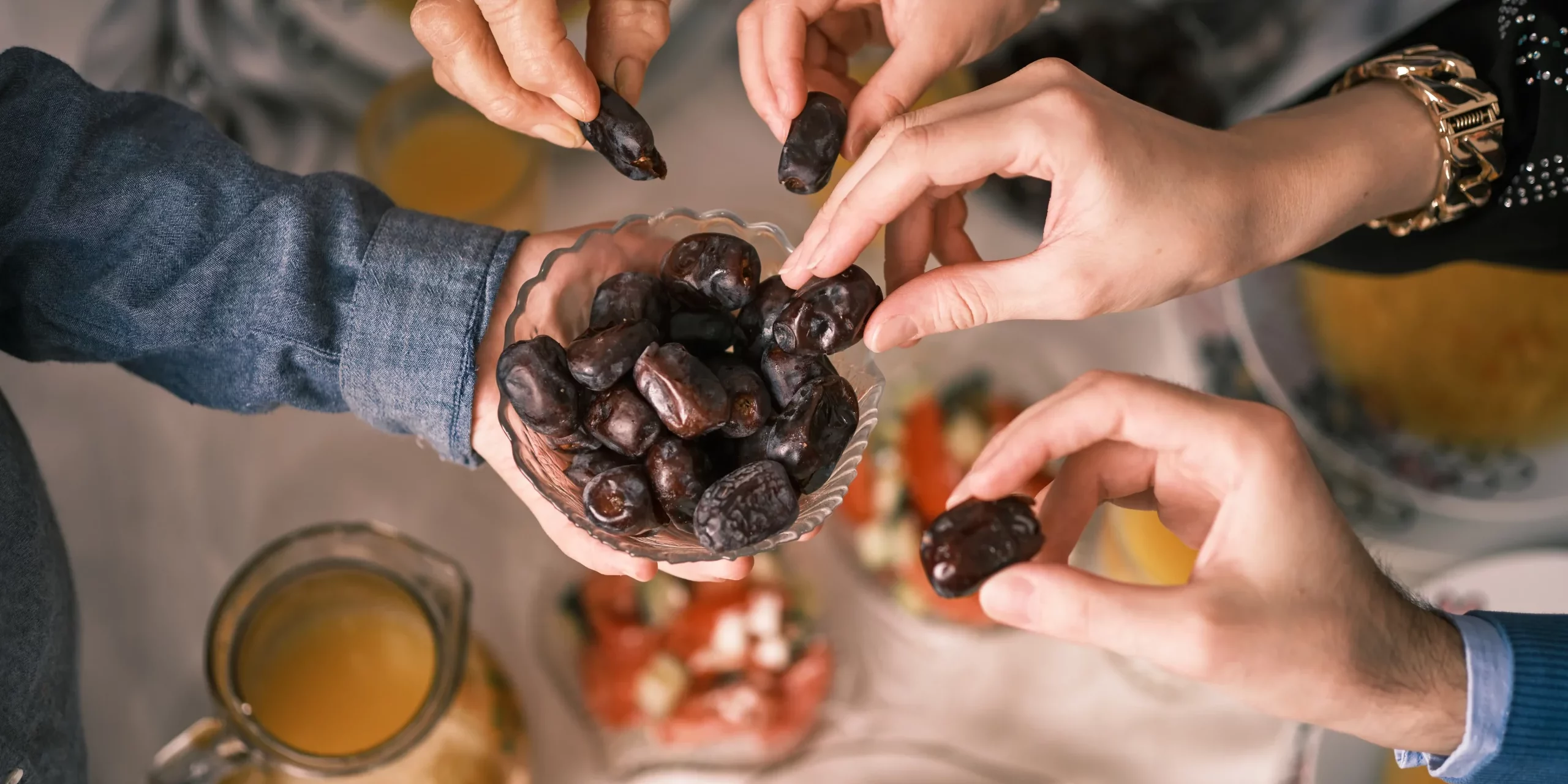 People hands sharing food in Salt Lake City, UT | Santosh Yoga Institute