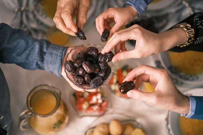 People hands sharing food in Salt Lake City, UT | Santosh Yoga Institute