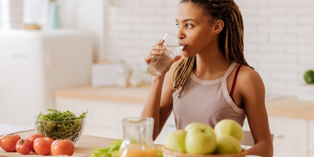 Young girl drinking water in Salt Lake City, UT | Santosh Yoga Institute