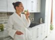 Young female drinking Water in the kitchen in Salt Lake City, UT | Santosh Yoga Institute